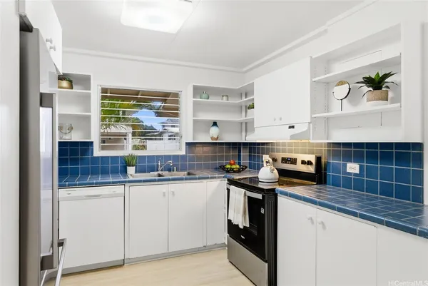 a kitchen with stainless steel appliances granite countertop a sink and cabinets