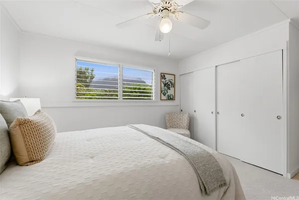 a bedroom with a large bed and a chandelier
