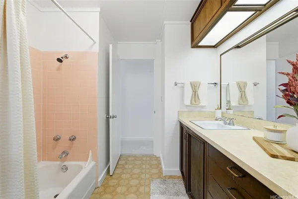 a bathroom with a tub sink and mirror