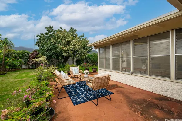 a backyard of a house with yard barbeque oven and outdoor seating