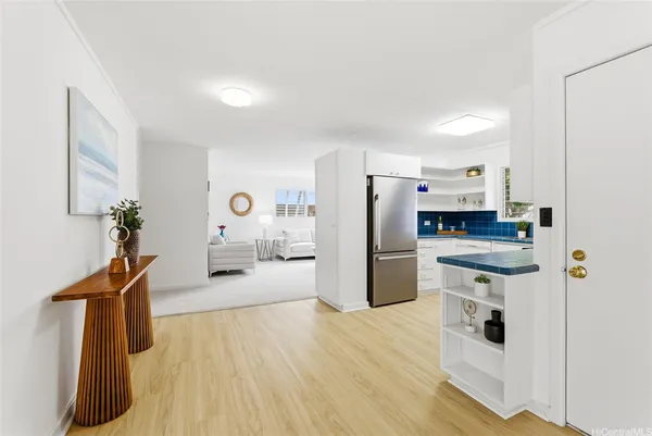 a kitchen with stainless steel appliances a refrigerator a stove a sink dishwasher and wooden floor