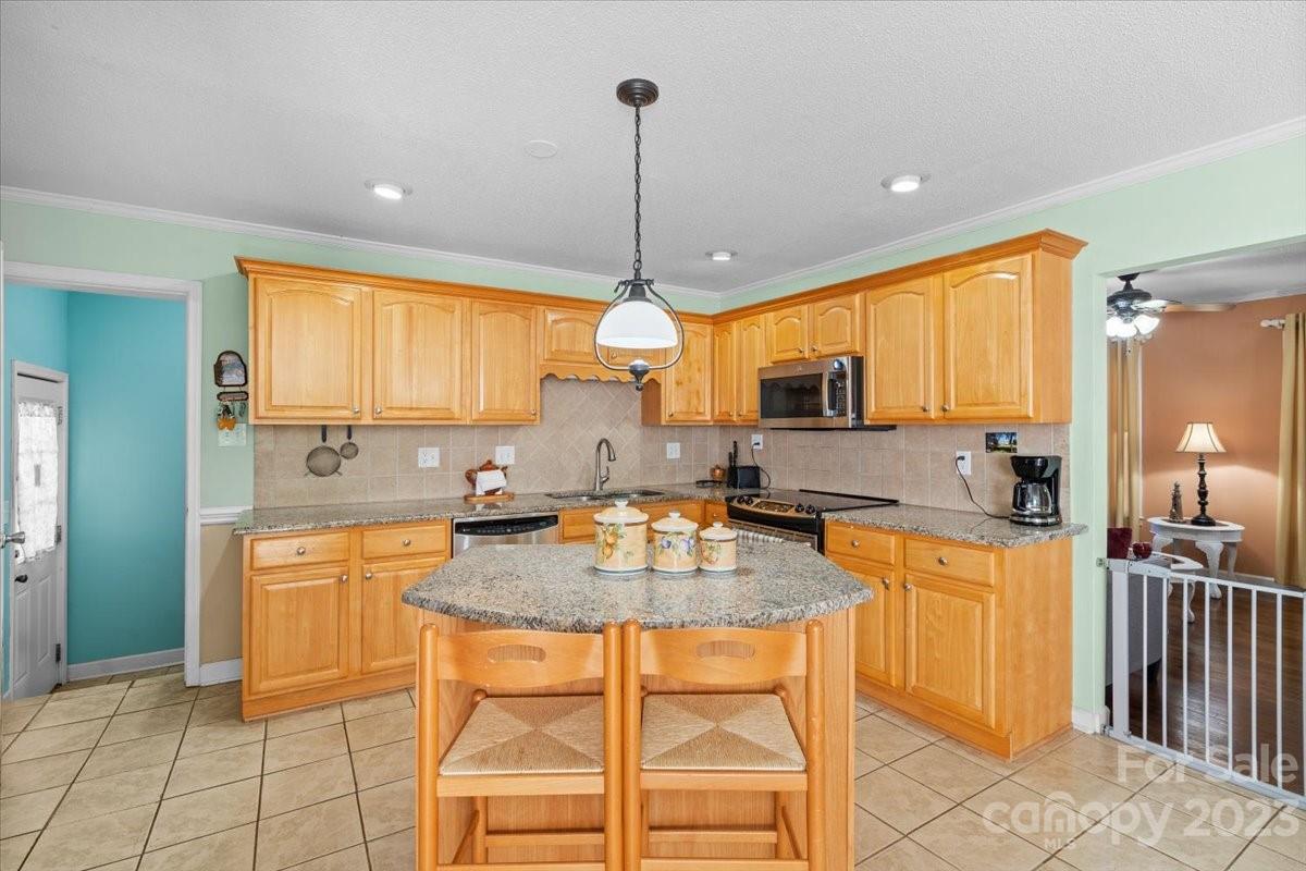 1429 Ebinport Road Rock Hill, SC 29732 - Photo 9 of 30 a kitchen with stainless steel appliances granite countertop a stove top oven a sink a dining table and chairs