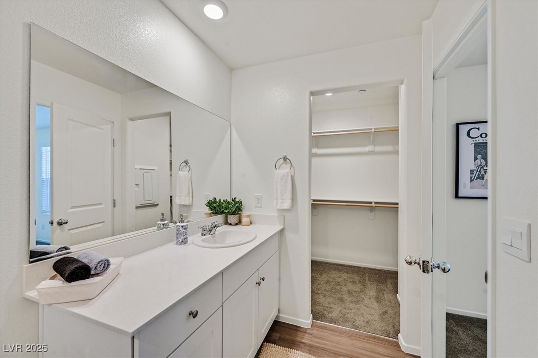 1906 Arietta Vista Street Henderson, NV 89044 - Photo 17 of 25 Bathroom featuring wood finished floors, vanity, a
