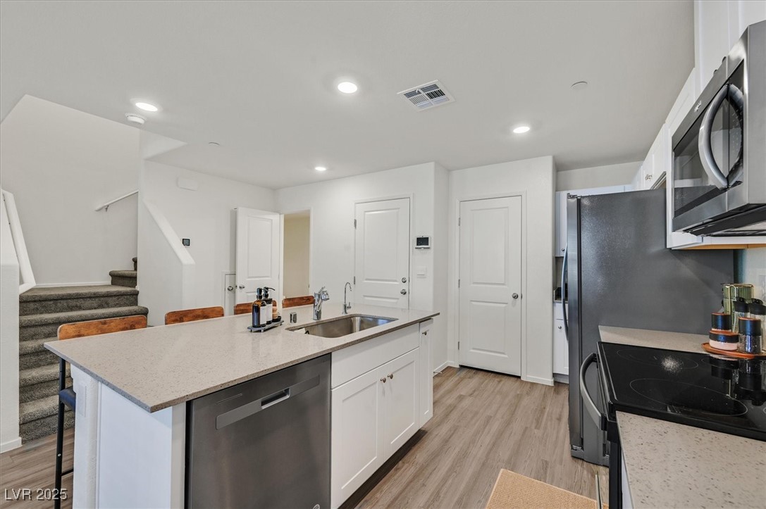 1906 Arietta Vista Street Henderson, NV 89044 - Photo 8 of 25 Kitchen with stainless steel appliances, white cab