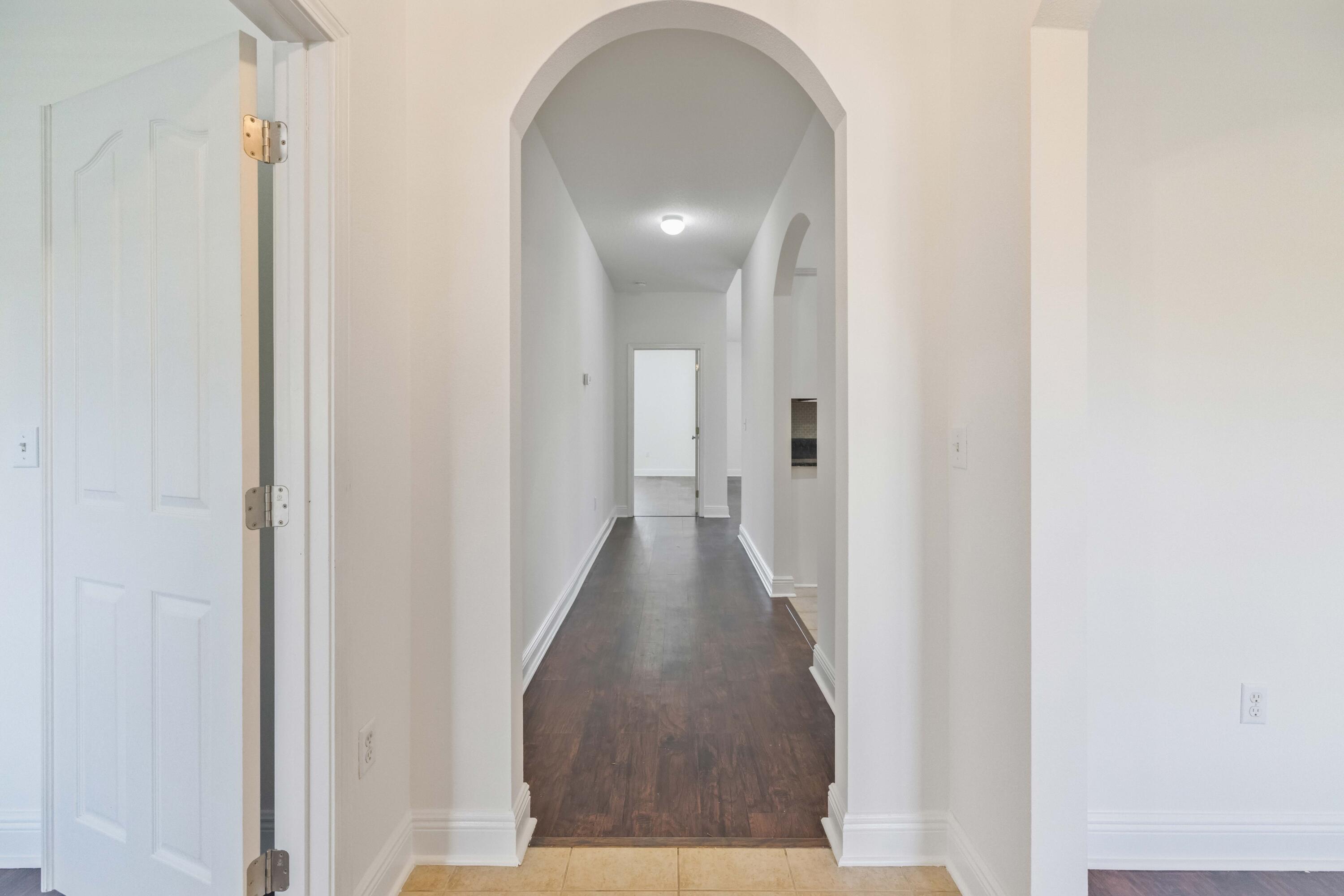 337 Mango Lane Freeport, FL 32439 - Photo 14 of 35 a view of a hallway with wooden floor
