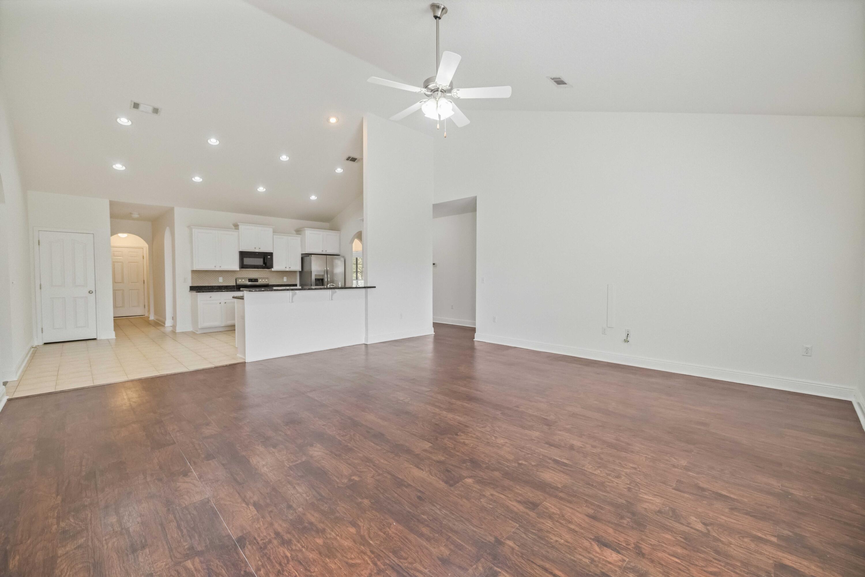 337 Mango Lane Freeport, FL 32439 - Photo 16 of 35 a view of a kitchen with a stove cabinets and wooden floor