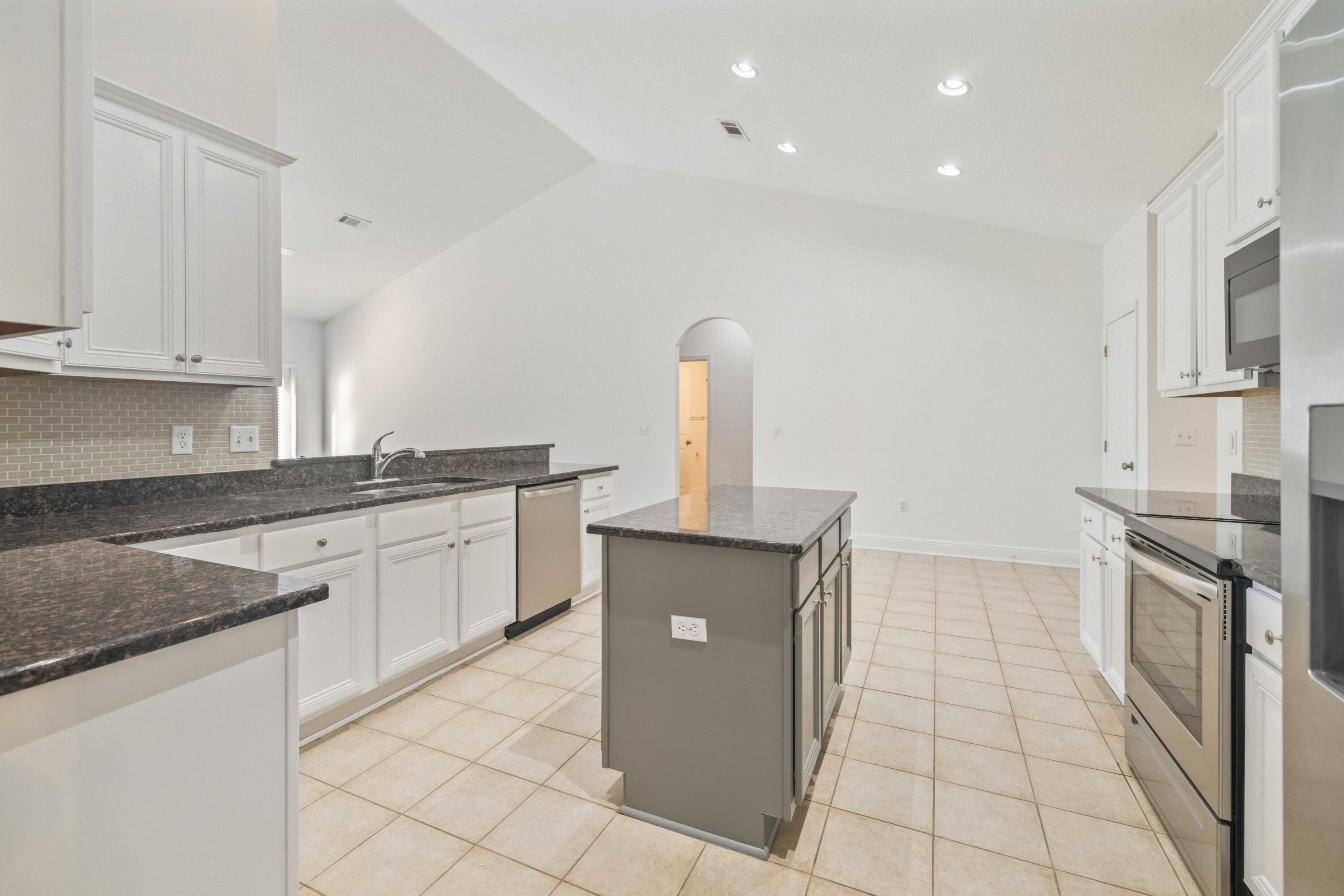 337 Mango Lane Freeport, FL 32439 - Photo 18 of 35 a kitchen with a sink and a stove top oven