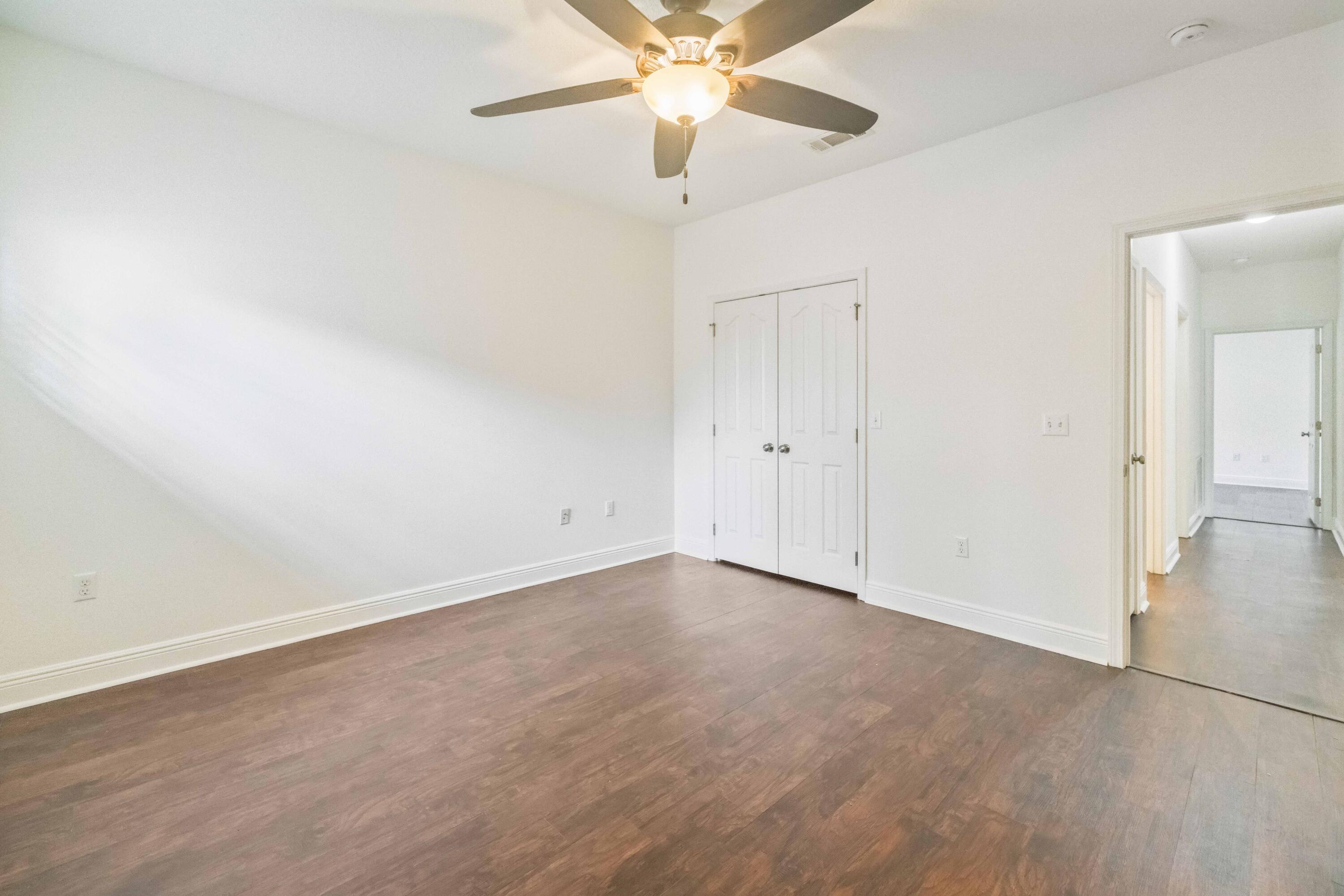 337 Mango Lane Freeport, FL 32439 - Photo 22 of 35 an empty room with closet and a chandelier fan