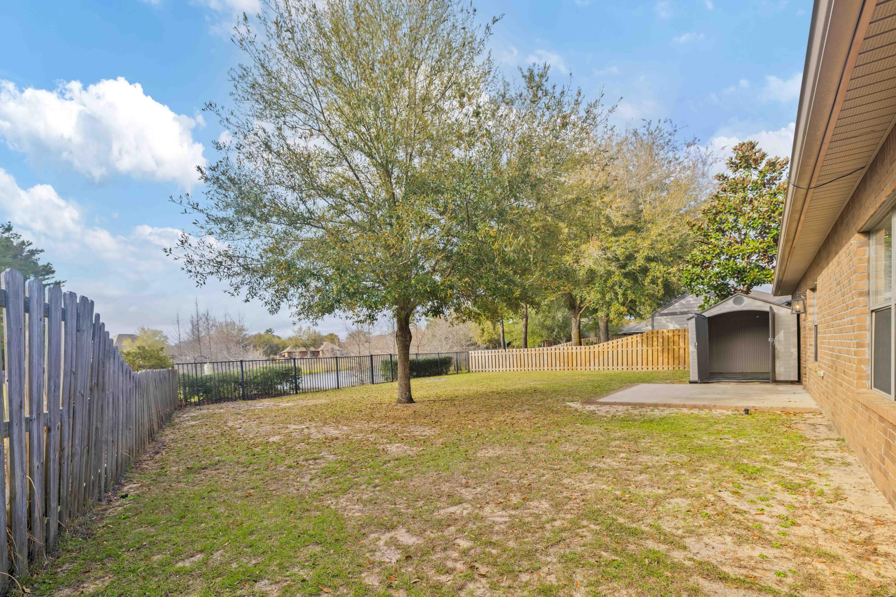 337 Mango Lane Freeport, FL 32439 - Photo 28 of 35 a yellow house with yard in front of it