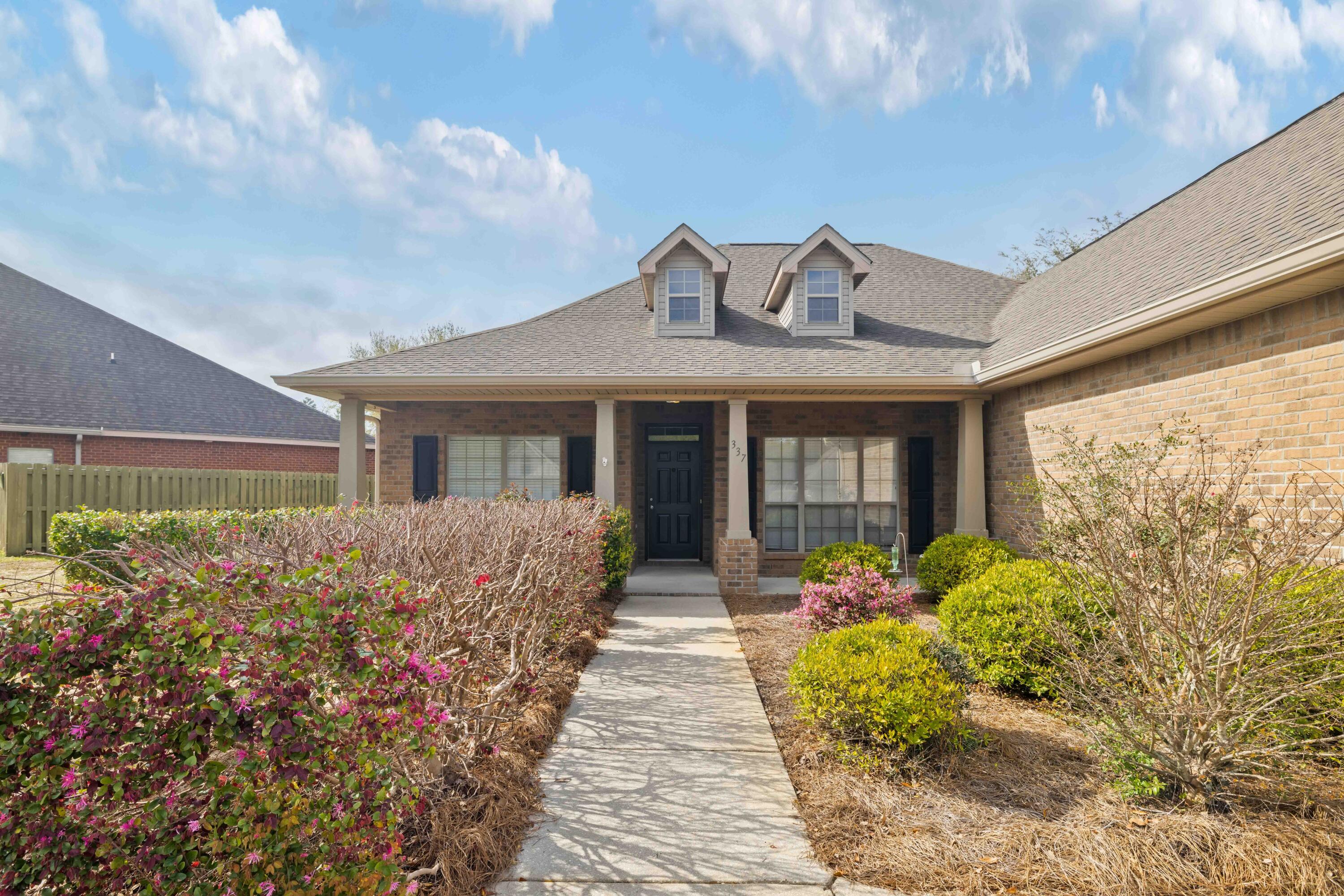 337 Mango Lane Freeport, FL 32439 - Photo 3 of 35 a front view of a house with garden