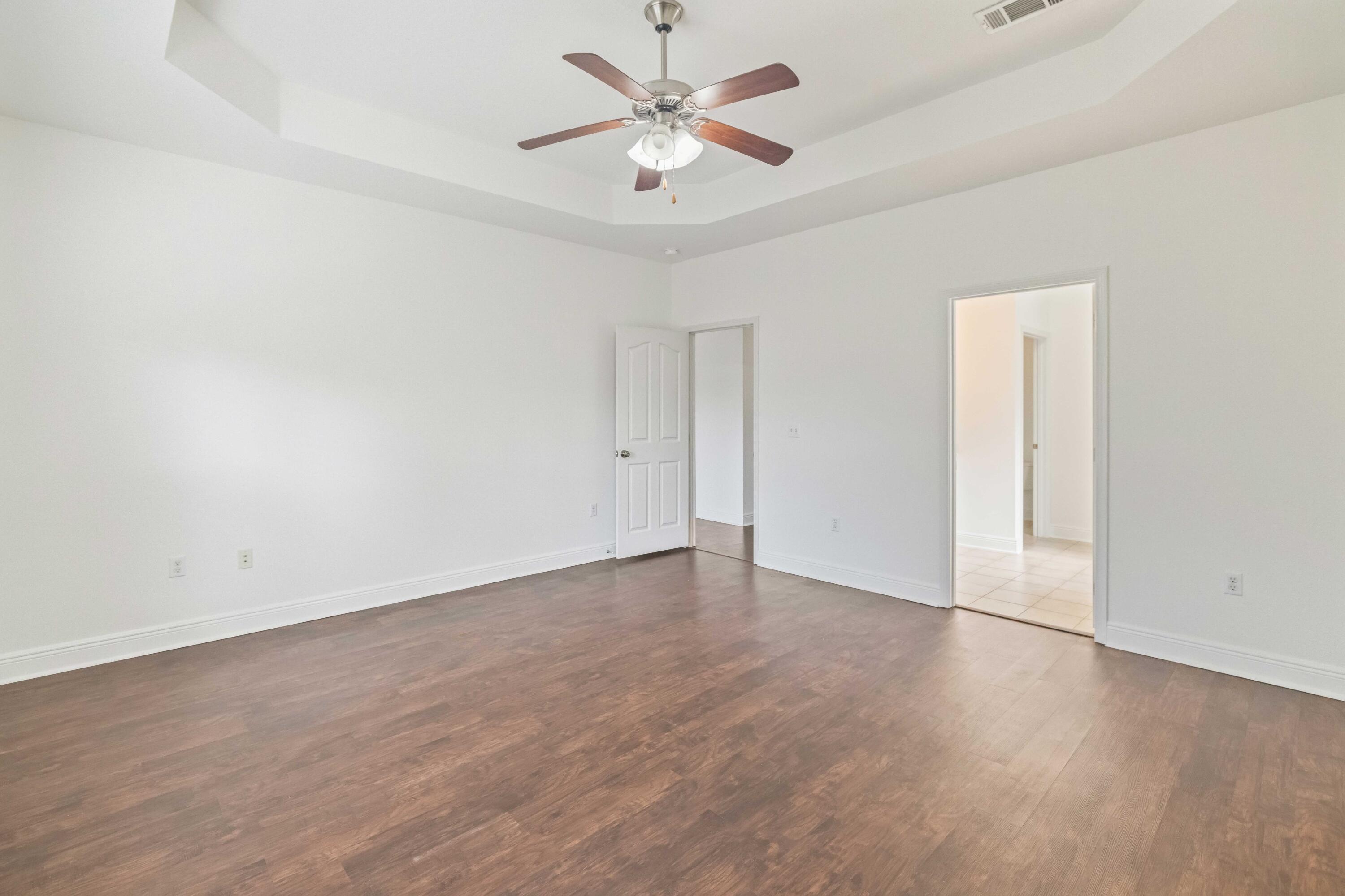 337 Mango Lane Freeport, FL 32439 - Photo 10 of 35 wooden floor in an empty room