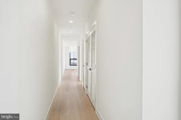 a view of a hallway with wooden floor