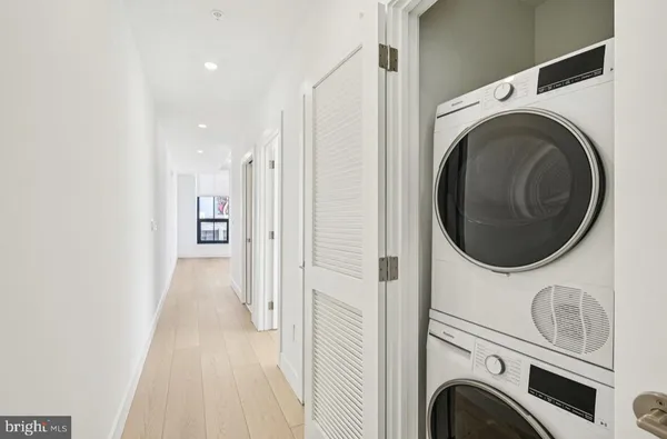 a view of a hallway with washer and dryer