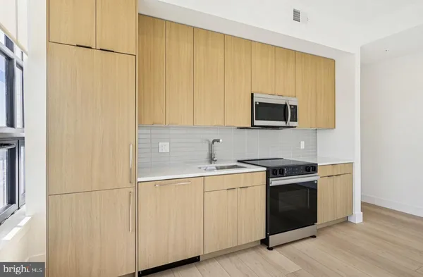 a kitchen with a sink and a stove top oven