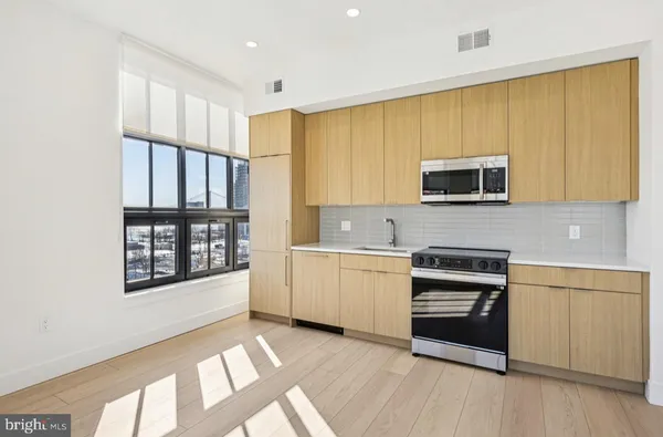 a kitchen with a stove a sink and a microwave