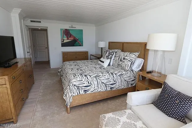 a bedroom with a bed and a flat screen television