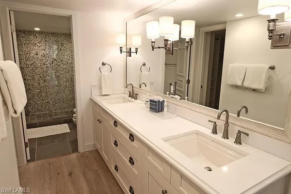 a bathroom with a sink double vanity and a mirror