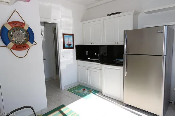 a kitchen with stainless steel appliances granite countertop a refrigerator and a stove