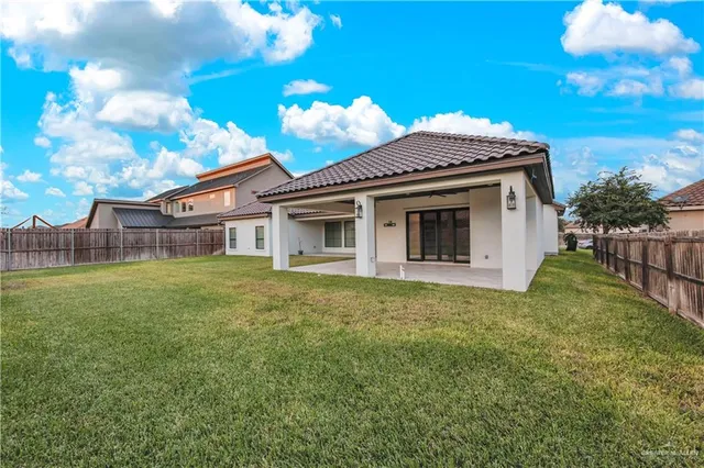 a view of a house with a backyard