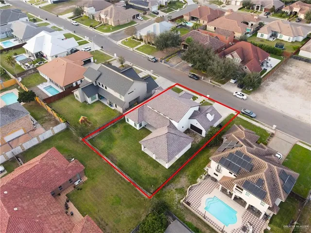 an aerial view of a tennis ground and a cars park