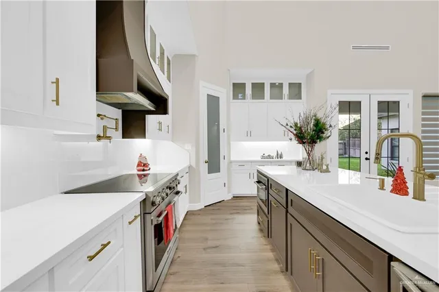a kitchen with a sink and a stove top oven