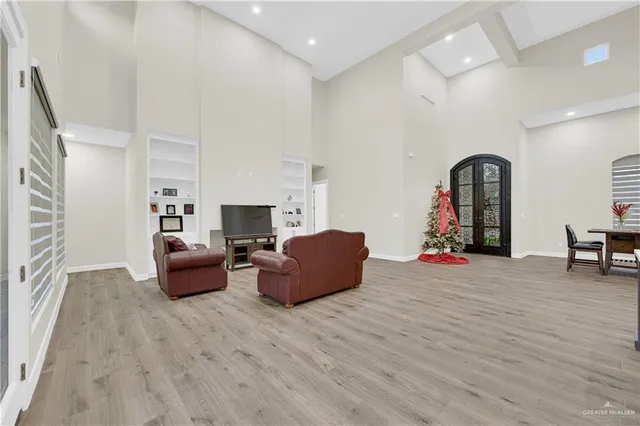 a living room with furniture and a wooden floor