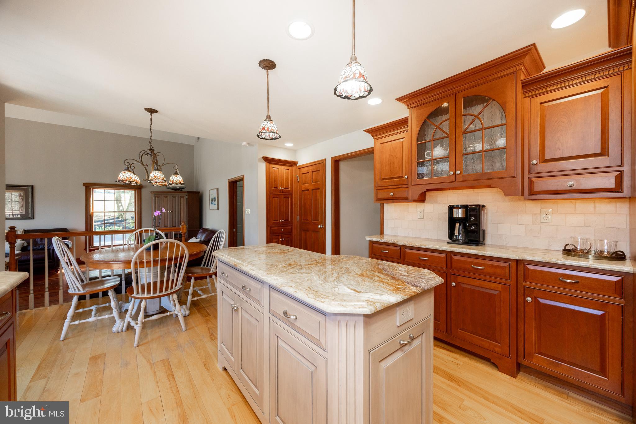 21 Krauser Road Downingtown, PA 19335 - Photo 14 of 54 a kitchen with stainless steel appliances granite countertop a kitchen island a stove a table and chairs