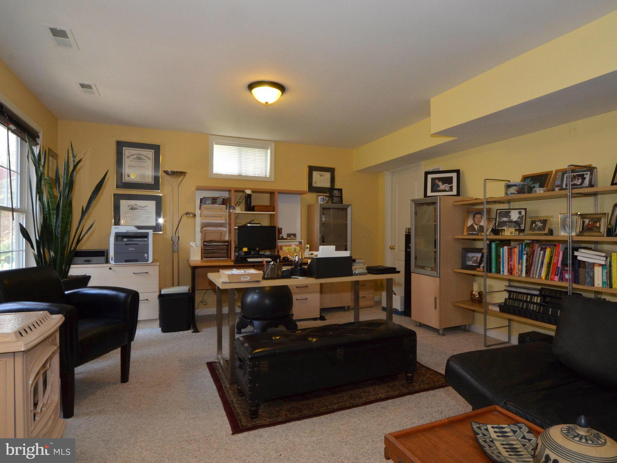 2566 Bear Den Road Frederick, MD 21701 - Photo 22 of 30 a living room with furniture a bookshelf and a flat screen tv