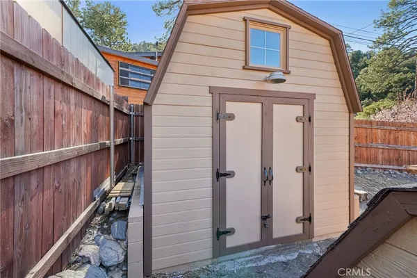 a view of a house with wooden deck front of house