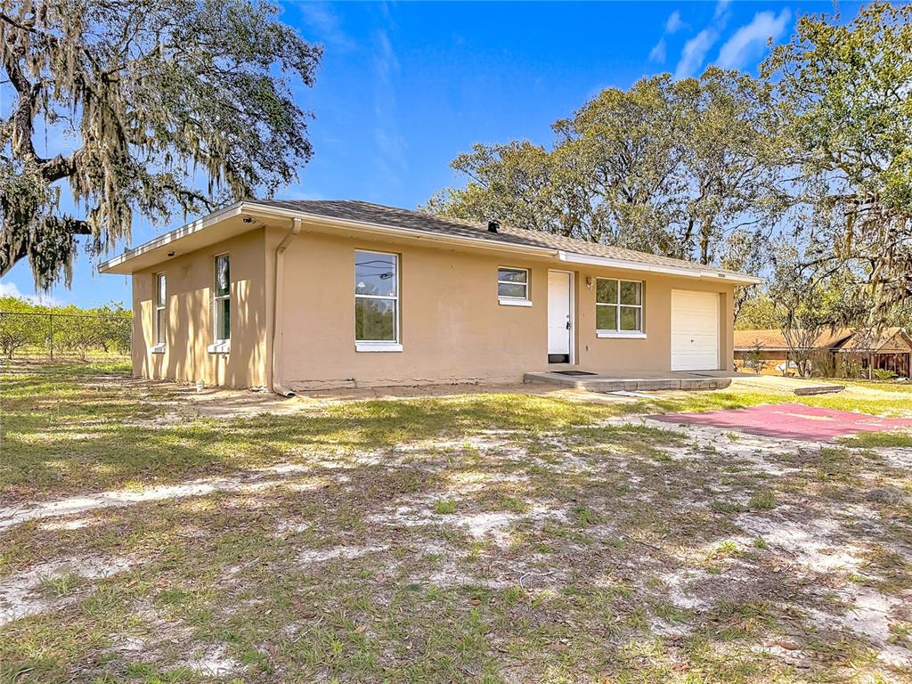 17331 County Road 33 Mascotte, FL 34753 - Photo 1 of 1 a front view of a house with a yard