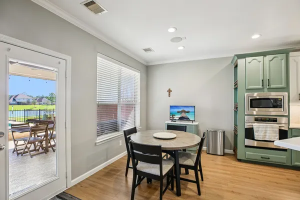a view of a dining room with furniture window and wooden floor