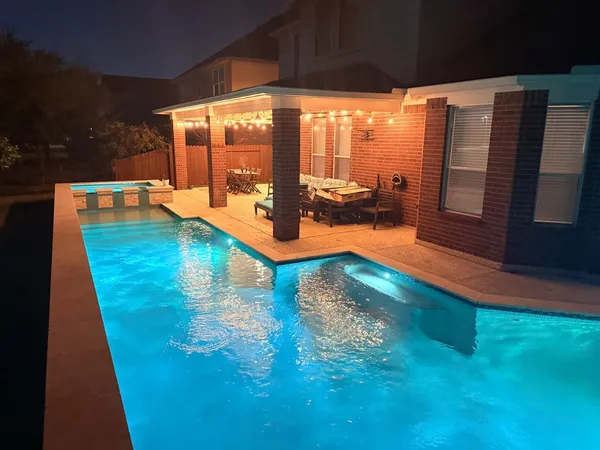 a view of a swimming pool with a patio
