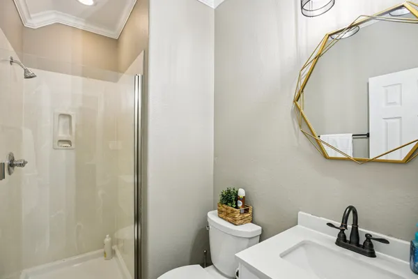 a bathroom with a sink a toilet and shower curtain