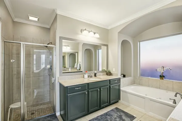 a spacious bathroom with a shower sink double vanity and mirror