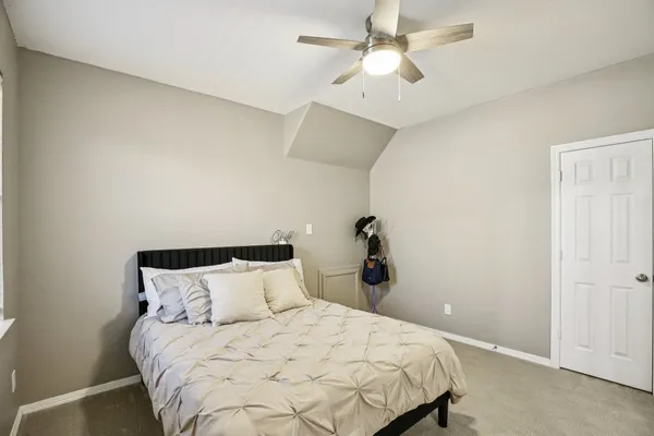 a bedroom with bed and window