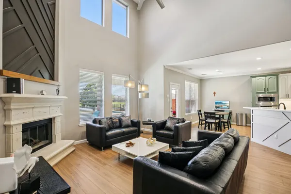 a living room with furniture a large window and a fireplace