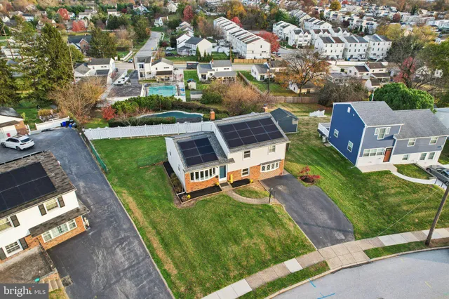 an aerial view of a house with a garden and trees