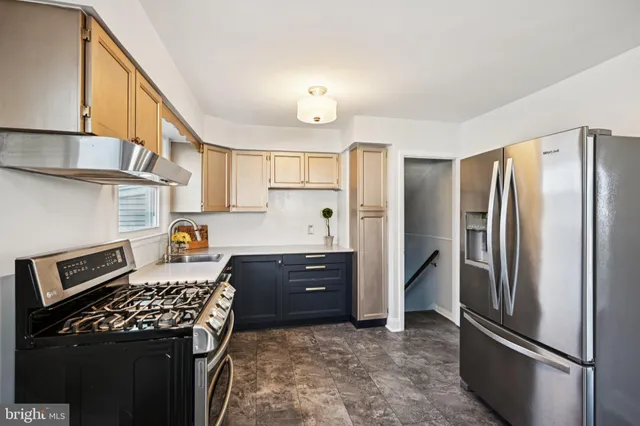 a kitchen with stainless steel appliances a stove a sink dishwasher and cabinets