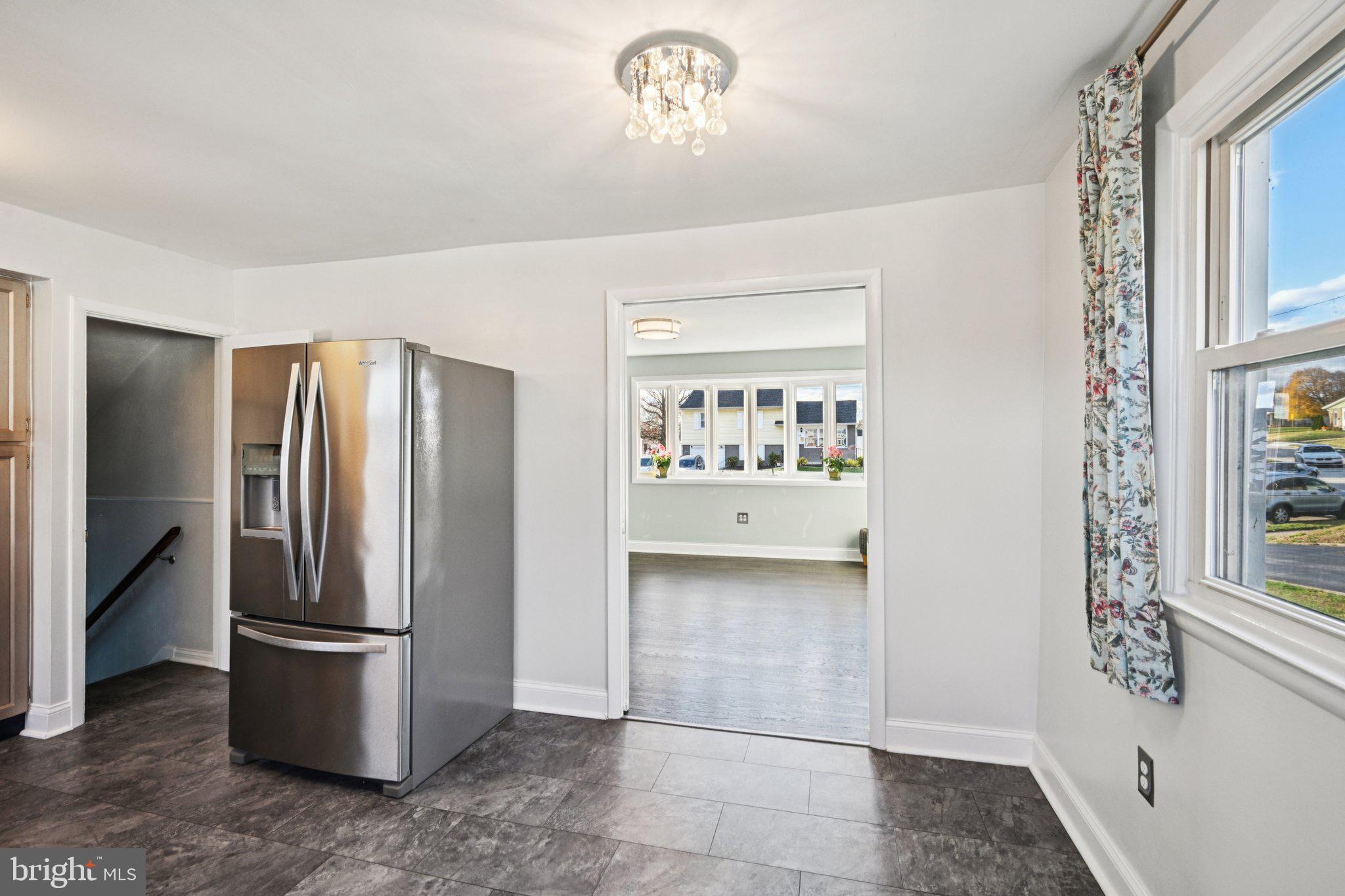 1211 Woodside Road Conshohocken, PA 19428 - Photo 12 of 55 a view of a refrigerator in kitchen and an empty room