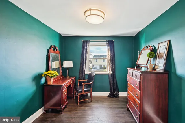 a view of a livingroom with wooden floor and a window