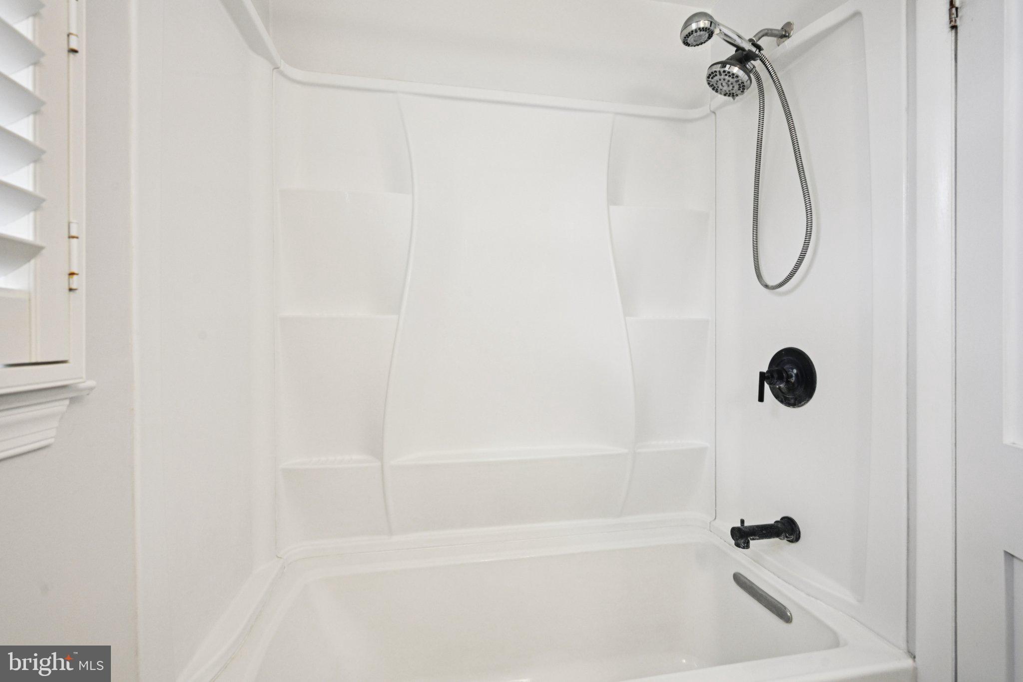 1211 Woodside Road Conshohocken, PA 19428 - Photo 21 of 55 a bathroom with a bath tub with a shower