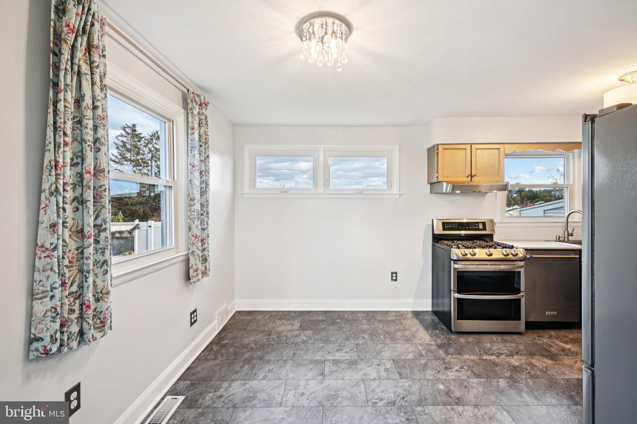 1211 Woodside Road Conshohocken, PA 19428 - Photo 26 of 55 a kitchen with stainless steel appliances granite countertop a stove and a refrigerator