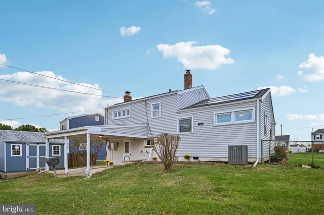 an aerial view of a house with a garden and lake view