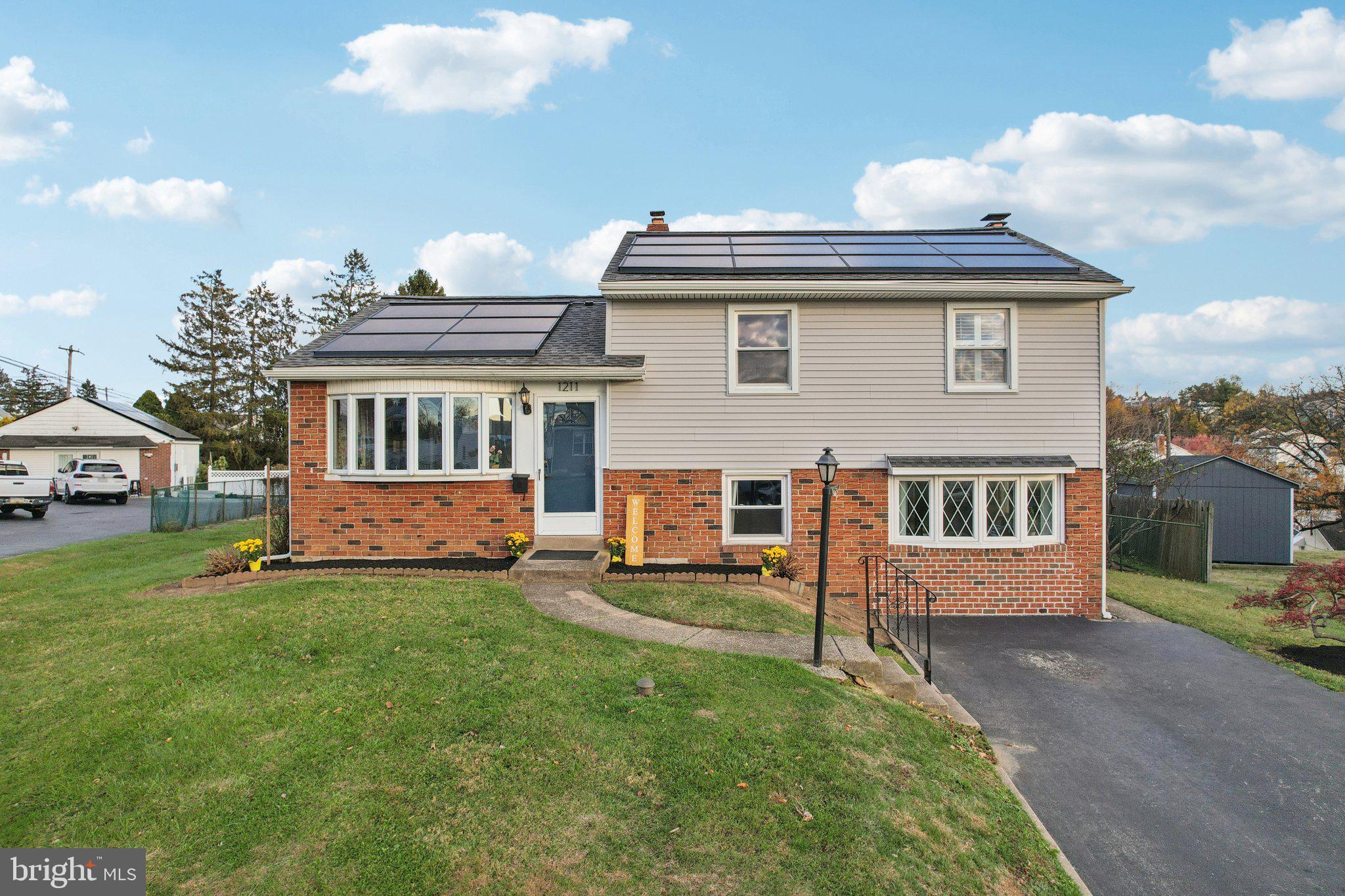 1211 Woodside Road Conshohocken, PA 19428 - Photo 40 of 55 a view of a house with a yard and sitting area