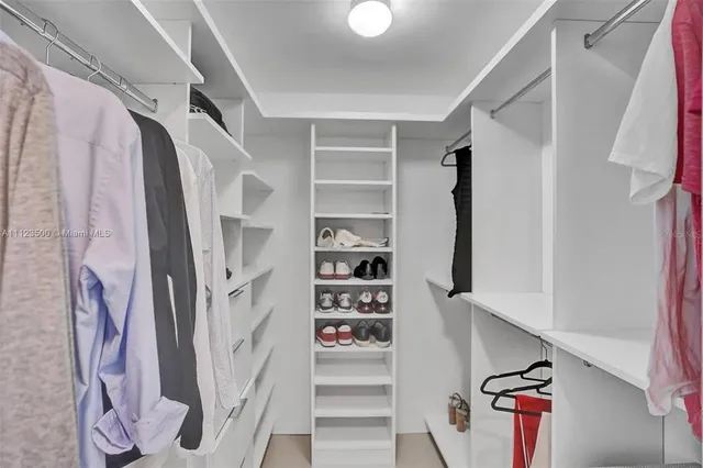 a bathroom with a double vanity sink toilet and mirror