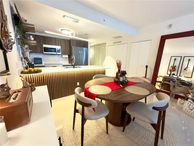 a kitchen with kitchen island a sink counter top space and stainless steel appliances