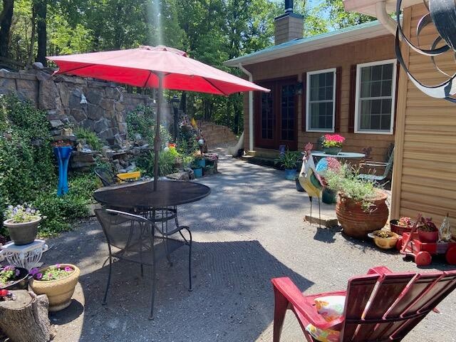 260 Deer Ridge Trail Ocoee, TN 37361 - Photo 12 of 72 a view of a backyard with table and chairs under an umbrella
