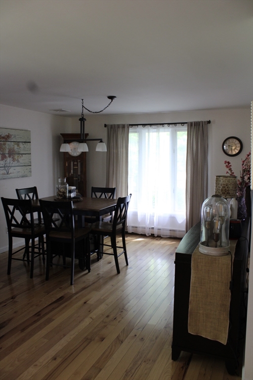 225 Braemoor Road Brockton, MA 02301 - Photo 19 of 29 a view of a dining room with furniture and wooden floor
