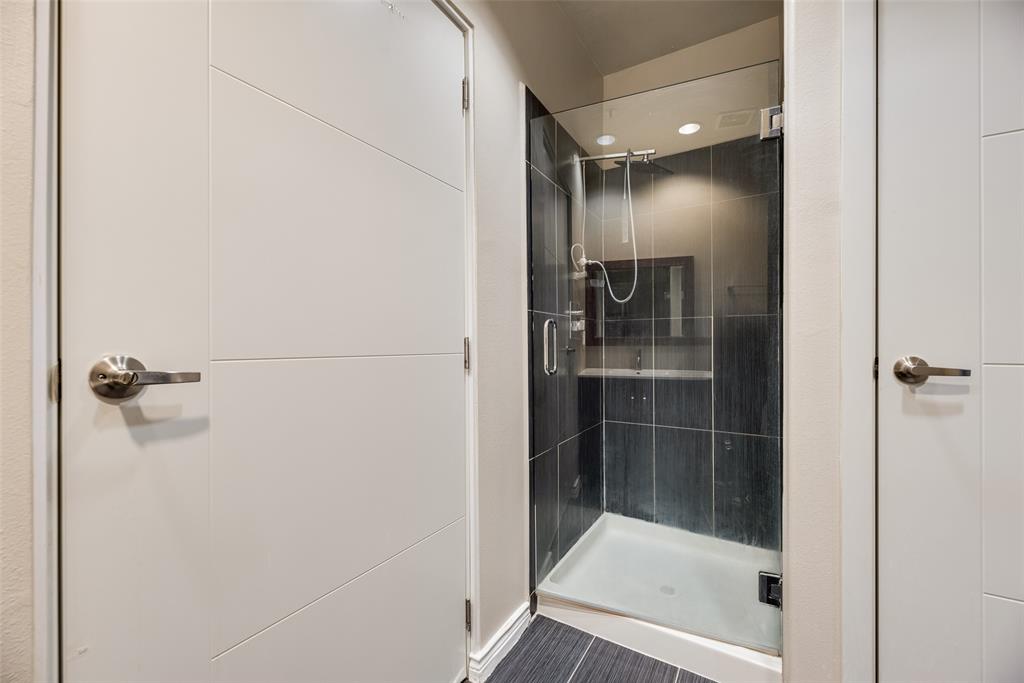 1100 West Trinity Mills Road, Unit 2040 Carrollton, TX 75006 - Photo 13 of 21 a bathroom with a glass shower door
