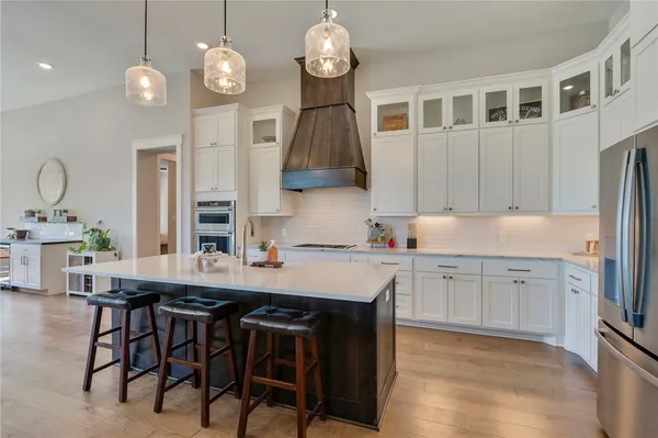 a kitchen with cabinets table and chairs